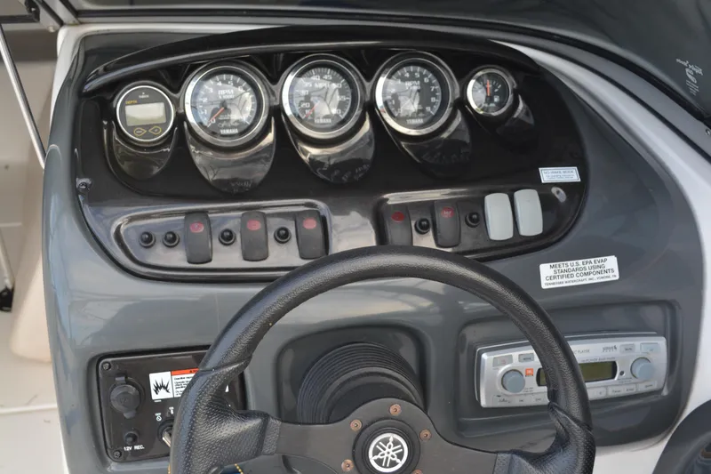 Slide: The Image of 2011 Yamaha AR210 boat dashboard with gauges and controls. - 18