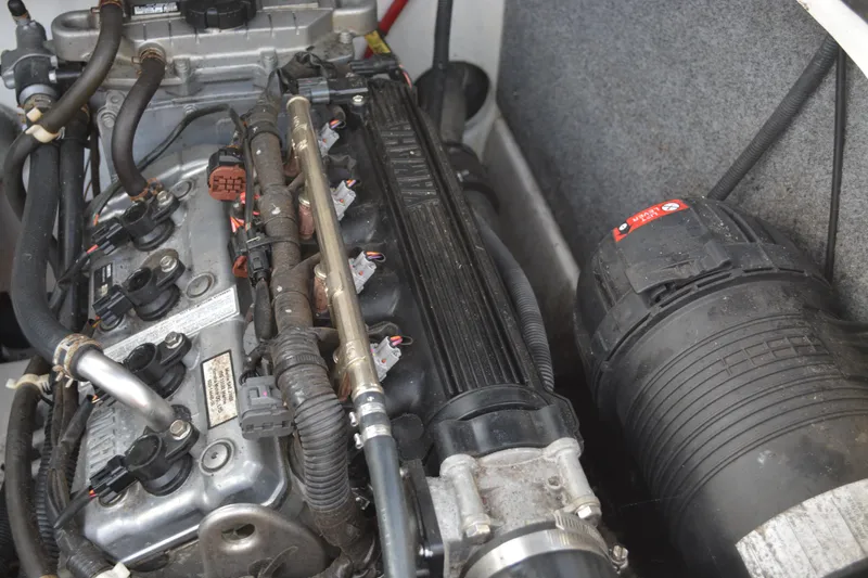 Slide: The Image of Engine compartment of a 2011 Yamaha Boats AR210, showcasing detailed components and wiring. - 21