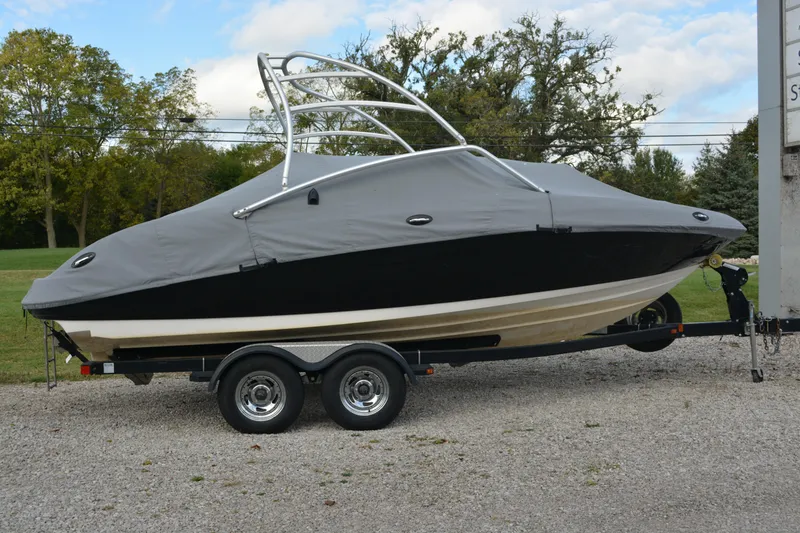 Slide: The Image of 2011 Yamaha AR210 boat on trailer, covered, parked outdoors. - 7