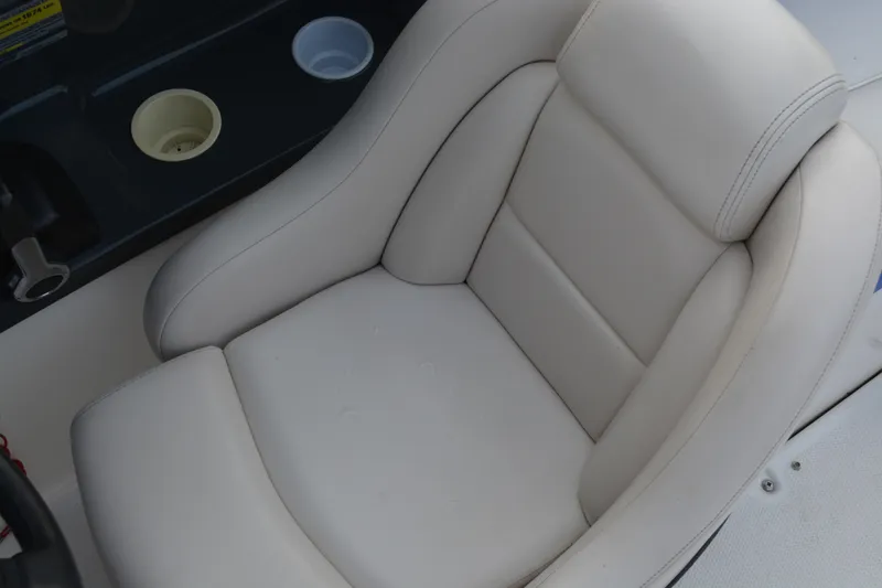 Slide: The Image of 2011 Yamaha AR210 boat seat with cup holders, featuring beige upholstery. - 9