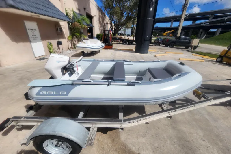 Slide: The Image of 2026 Gala A300HD inflatable boat on trailer under cloudy sky. - 5