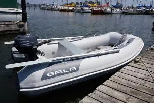 Slide: The Image of 2026 Gala A300HD inflatable boat docked at a marina with outboard motor. - 8