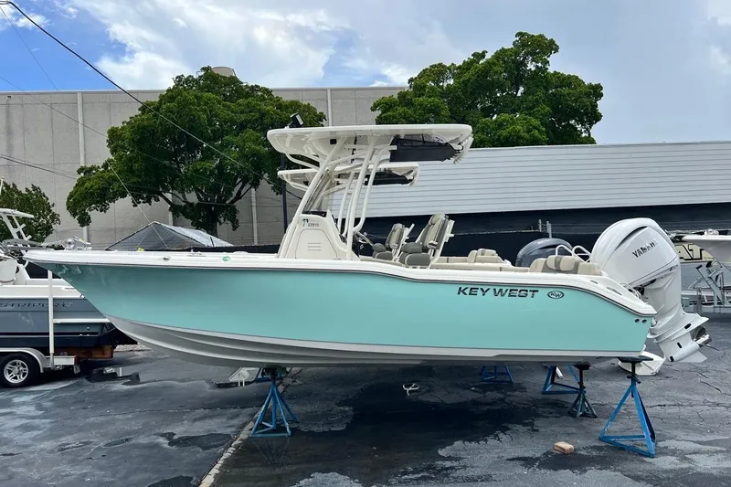 The Image of 2026 Key West 239 FS boat on stands, light blue hull, outdoor display. - 1