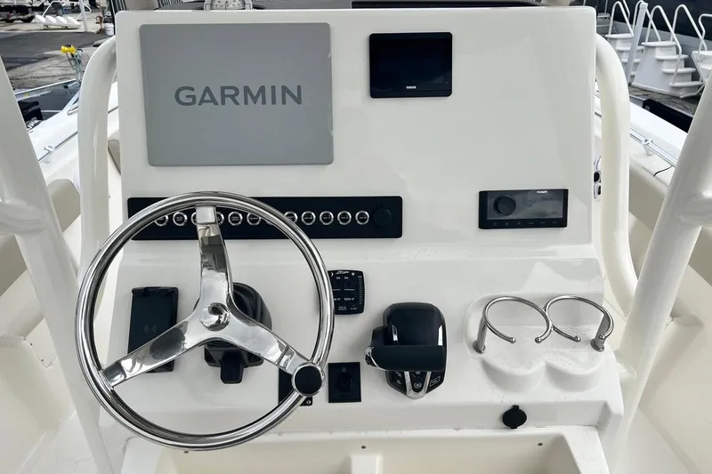 Slide: The Image of 2026 Key West 239 FS boat dashboard with Garmin navigation system and steering wheel. - 10