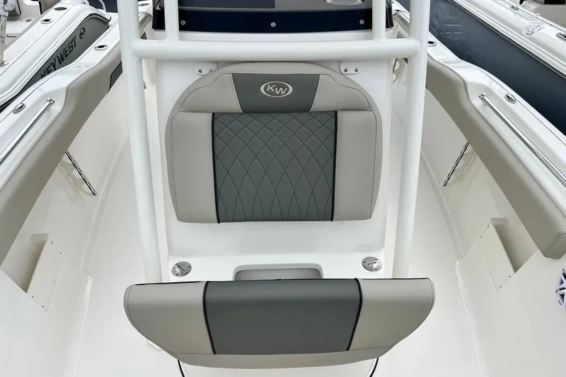 Slide: The Image of 2026 Key West 239 FS boat interior with gray cushioned seating and white framework. - 14
