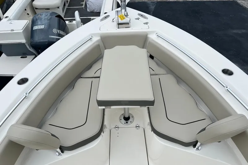 Slide: The Image of 2026 Key West 239 FS boat interior with cushioned seating and table setup. - 17