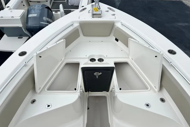 Slide: The Image of 2026 Key West 239 FS boat interior with open storage compartments and Yamaha engine. - 19