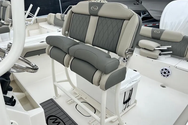 Slide: The Image of 2026 Key West 239 FS boat interior with cushioned seating and steering wheel. - 23