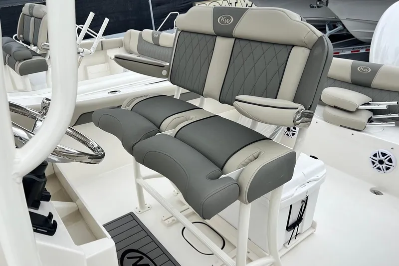 Slide: The Image of 2026 Key West 239 FS boat interior with cushioned seating and steering wheel. - 24