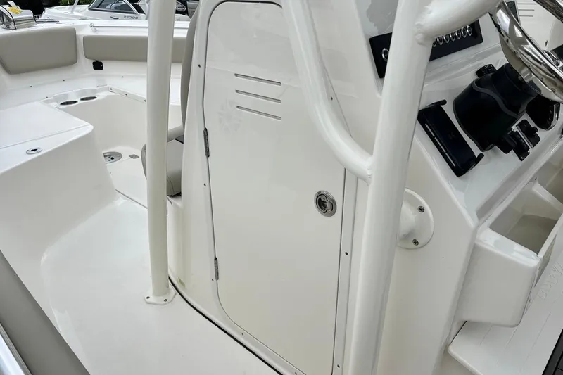 Slide: The Image of 2026 Key West 239 FS boat interior with steering console and seating area. - 37