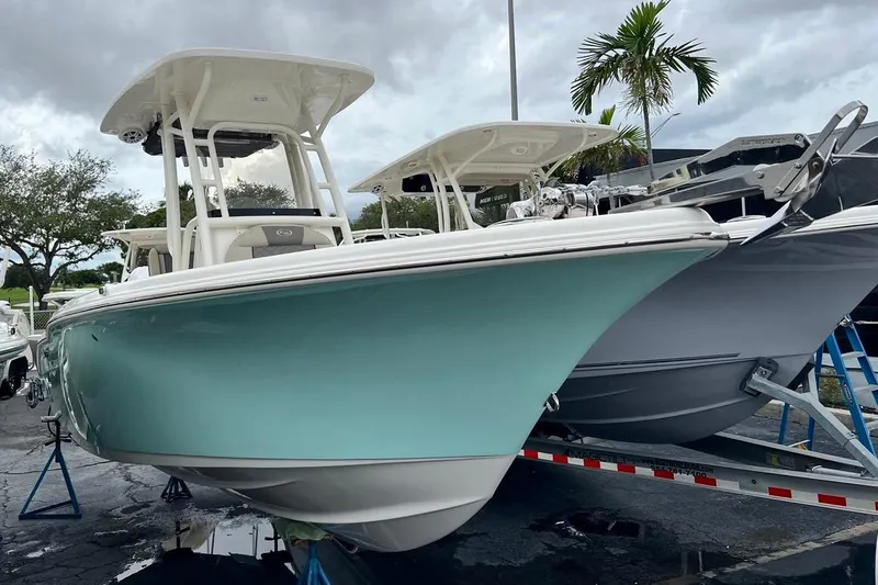 Slide: The Image of 2026 Key West 239 FS boat in a showroom, featuring a sleek design and light blue hull. - 4