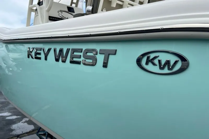 Slide: The Image of 2026 Key West 239 FS boat, turquoise hull with logo, docked. - 47
