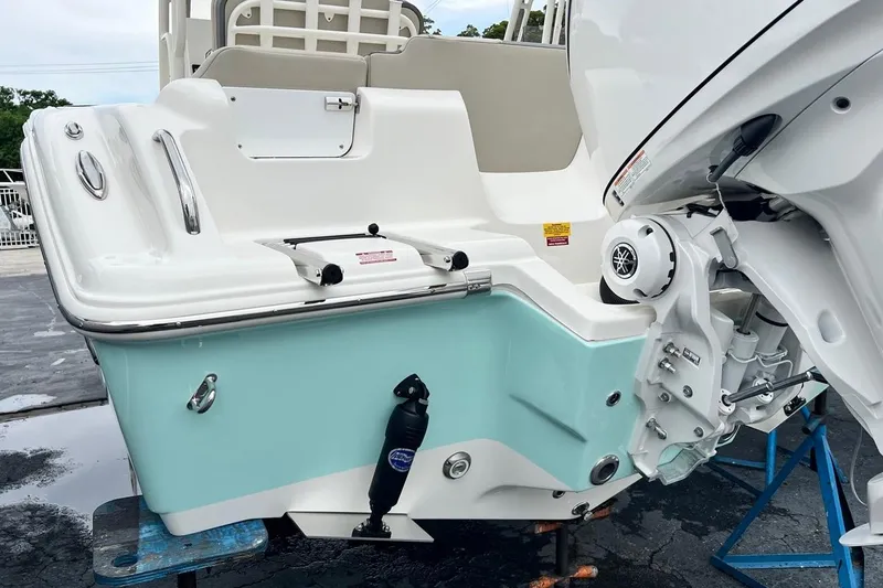 Slide: The Image of 2026 Key West 239 FS boat stern with outboard motor, displayed on a stand. - 7