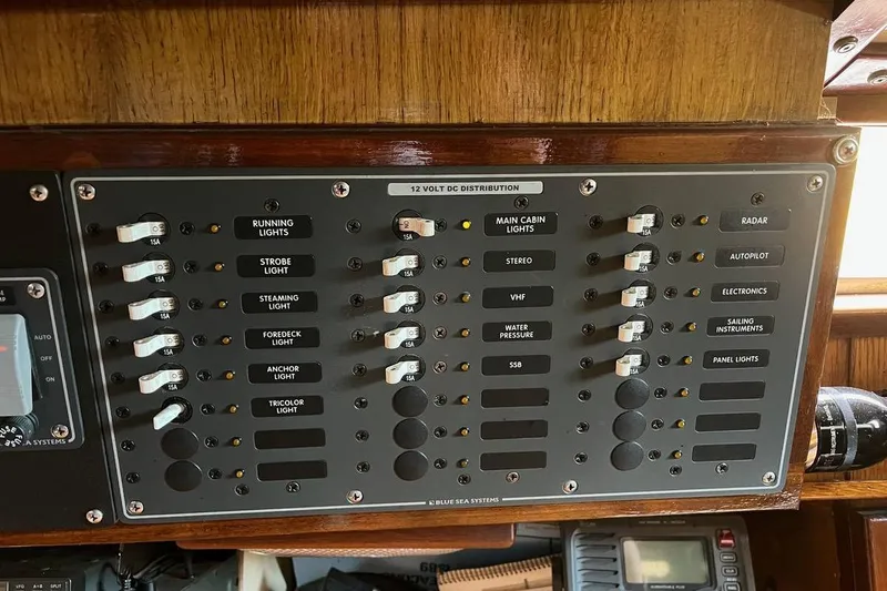 Slide: The Image of Control panel of a 1989 Fortuna 37 yacht with labeled switches and indicators. - 11