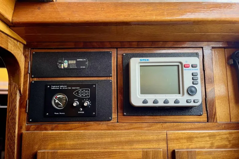 Slide: The Image of Control panel of a 1989 Fortuna 37 boat with navigation and monitoring systems. - 12