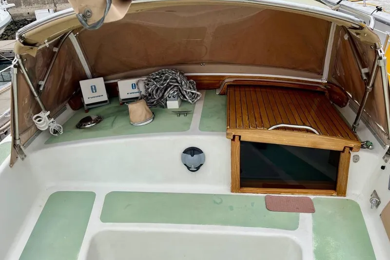 Slide: The Image of 1989 Fortuna 37 boat cockpit with wooden hatch, rope, and navigation equipment. - 4