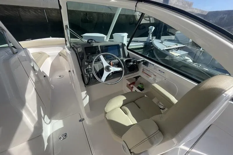 Slide: The Image of 2016 Pursuit DC 265 Dual Console boat interior with steering wheel and dashboard. - 14