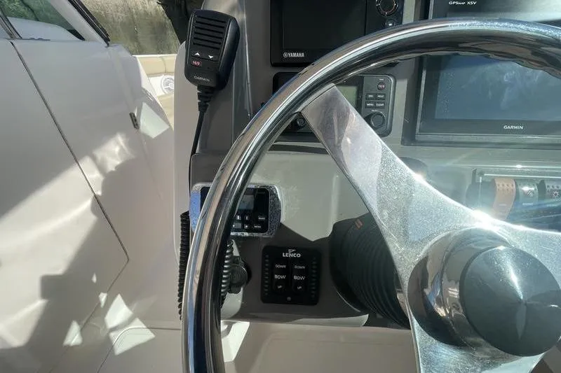 Slide: The Image of Steering wheel and controls of 2016 Pursuit DC 265 Dual Console boat. - 15