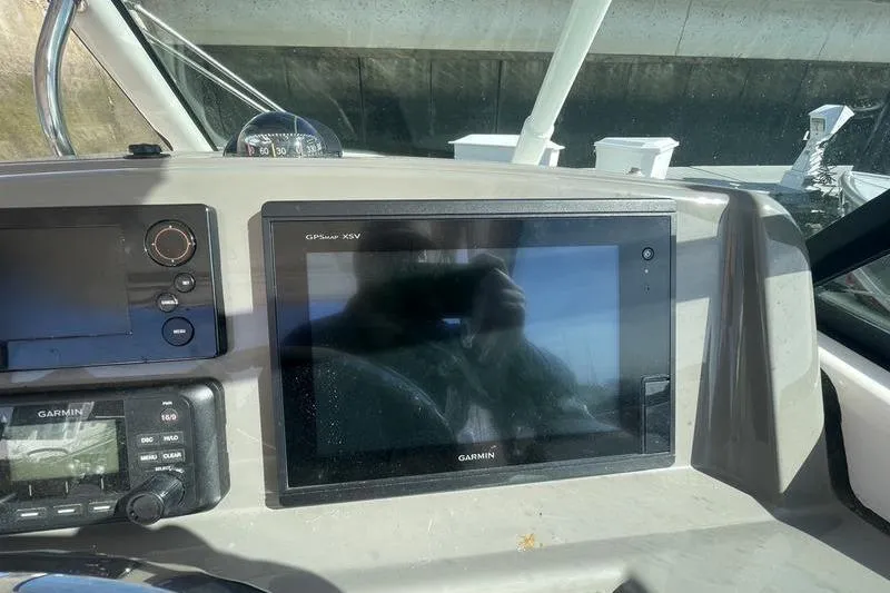 Slide: The Image of Dashboard of 2016 Pursuit DC 265 Dual Console with Garmin GPS display. - 19