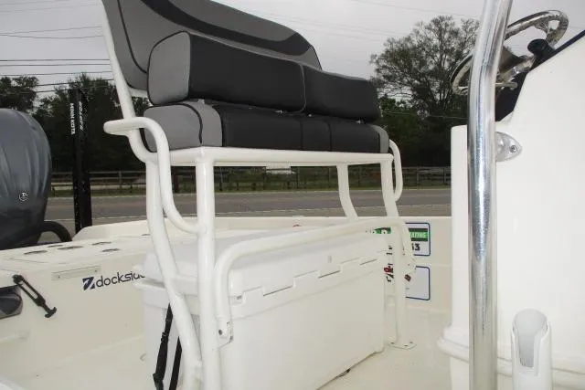 Slide: The Image of 2023 Skeeter SX240 boat seating and console with storage compartment. - 11