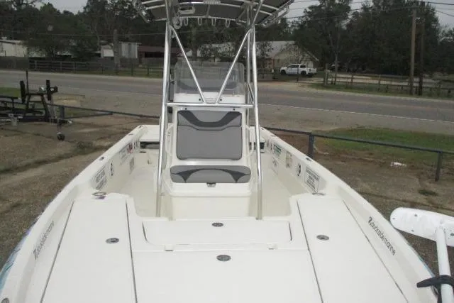 Slide: The Image of 2023 Skeeter SX240 boat with center console and seating, parked near a road. - 13