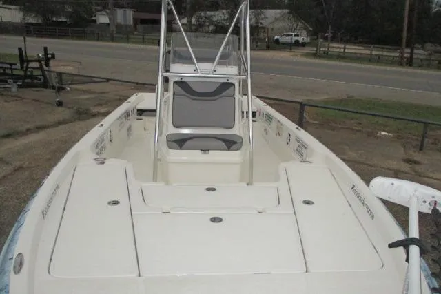 Slide: The Image of 2023 Skeeter SX240 boat with center console, parked on a trailer near a road. - 14