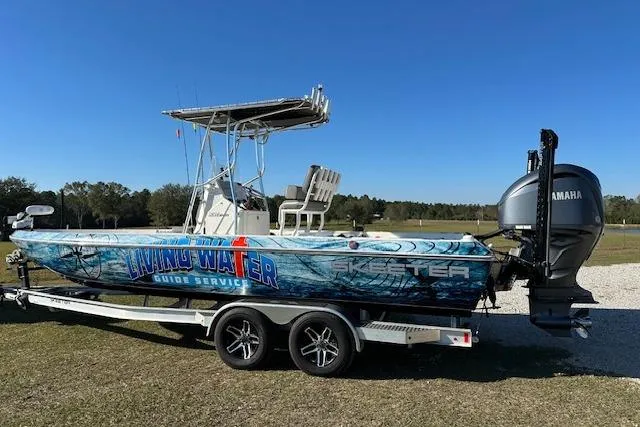 Slide: The Image of 2023 Skeeter SX240 boat with Yamaha engine on trailer, featuring "Living Water Guide Service" graphics. - 6