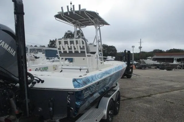 Slide: The Image of 2023 Skeeter SX240 boat on trailer, featuring Yamaha engine, parked outdoors. - 7
