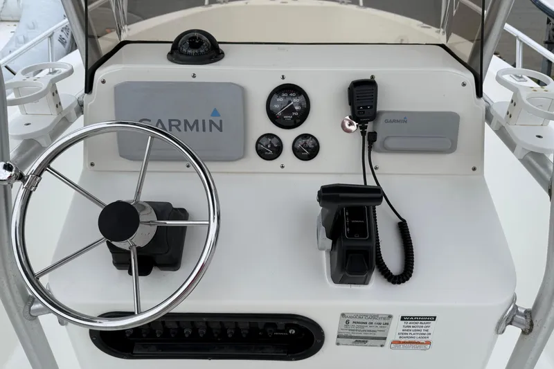 Slide: The Image of Center console of 2007 Mako 192 boat with Garmin navigation system and controls. - 10