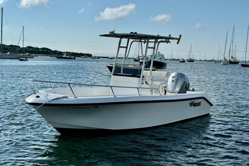 Slide: The Image of 2007 Mako 192 Center Console boat on calm water with sailboats in the background. - 4