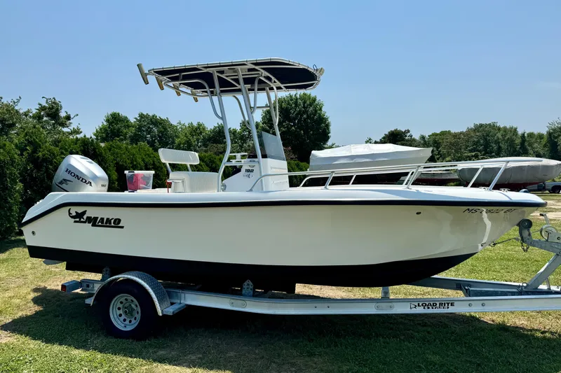 Slide: The Image of 2007 Mako 192 Center Console boat on trailer, parked on grass, with Honda outboard motor. - 6
