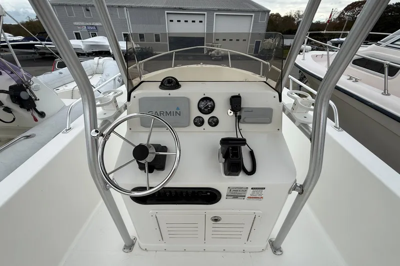 Slide: The Image of 2007 Mako 192 Center Console boat dashboard with steering wheel and Garmin equipment. - 9