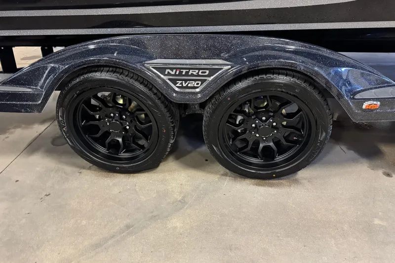 Slide: The Image of Black wheels on a 2026 Nitro ZV20 Sport Pro trailer, parked indoors. - 3