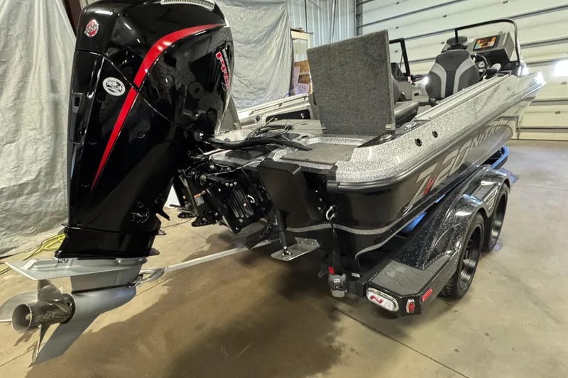 Slide: The Image of 2026 Nitro ZV20 Sport Pro boat with powerful outboard motor in a garage setting. - 4