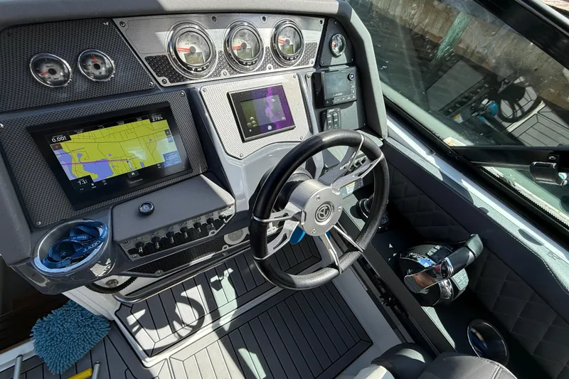 Slide: The Image of 2019 Cruisers Yachts 338 Outboard helm with navigation screens and steering wheel. - 11