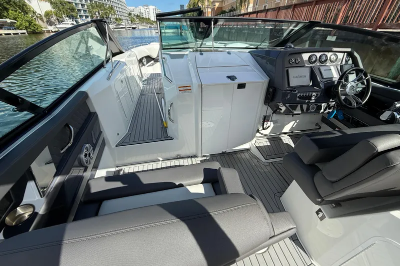 Slide: The Image of 2019 Cruisers Yachts 338 Outboard interior with modern dashboard and seating. - 12