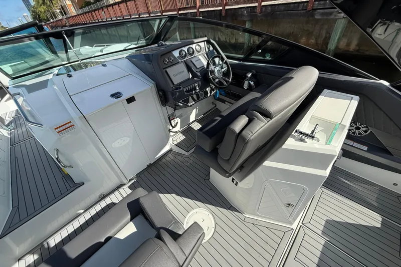 Slide: The Image of 2019 Cruisers Yachts 338 Outboard cockpit with helm, seating, and control panel. - 13