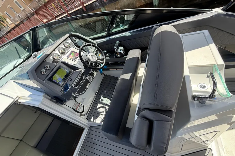 Slide: The Image of 2019 Cruisers Yachts 338 Outboard cockpit with modern controls and seating. - 21