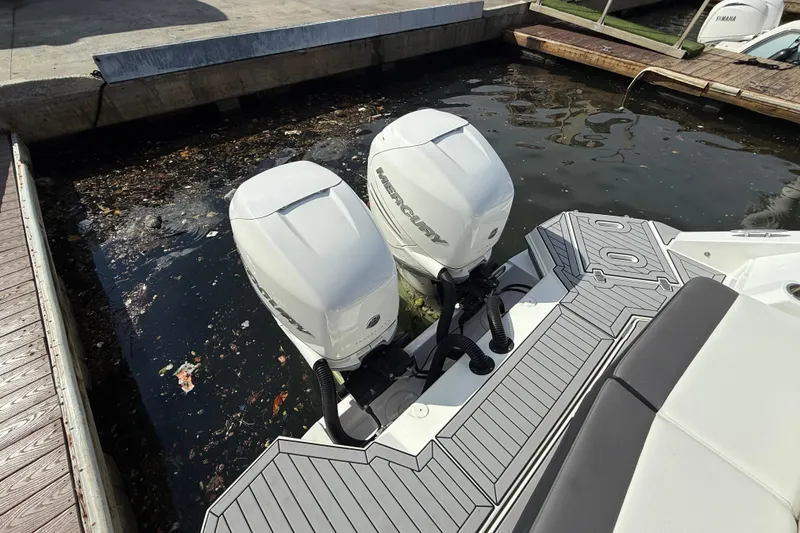Slide: The Image of 2019 Cruisers Yachts 338 Outboard with twin Mercury engines docked in a marina. - 29