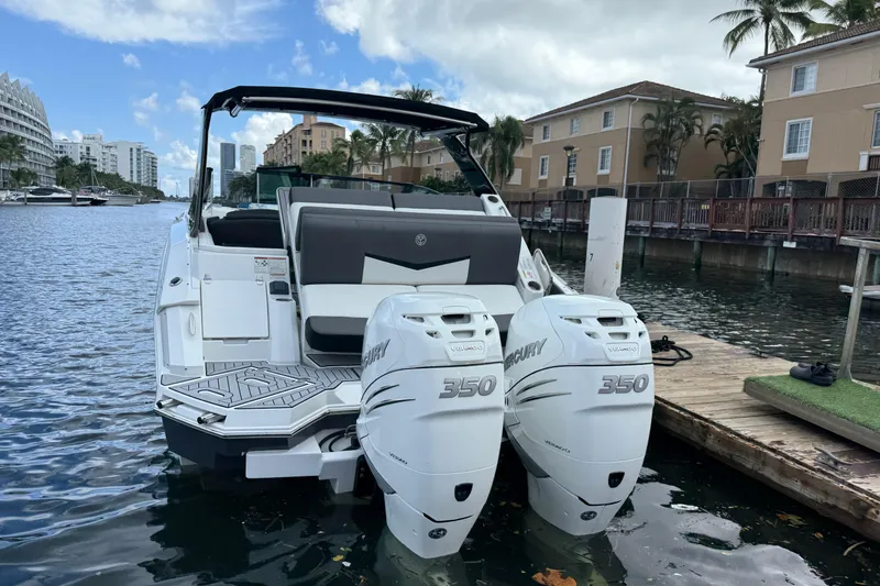 Slide: The Image of 2019 Cruisers Yachts 338 Outboard with twin Mercury 350 engines docked by waterfront homes. - 3