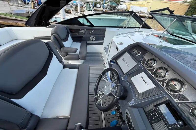 Slide: The Image of 2019 Cruisers Yachts 338 Outboard cockpit with Garmin and Mercury controls, luxurious seating. - 32