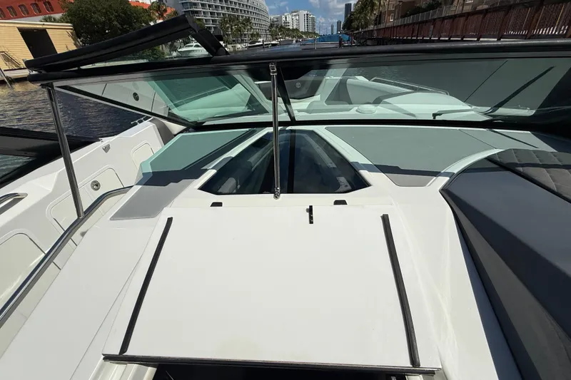 Slide: The Image of 2019 Cruisers Yachts 338 Outboard boat deck with open windshield, docked by waterfront. - 34