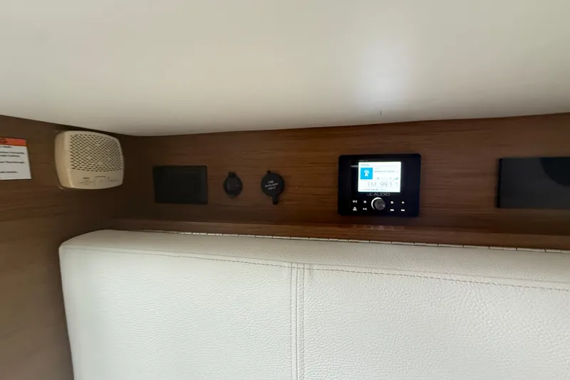 Slide: The Image of Interior of 2019 Cruisers Yachts 338 Outboard featuring audio controls and speaker system. - 37