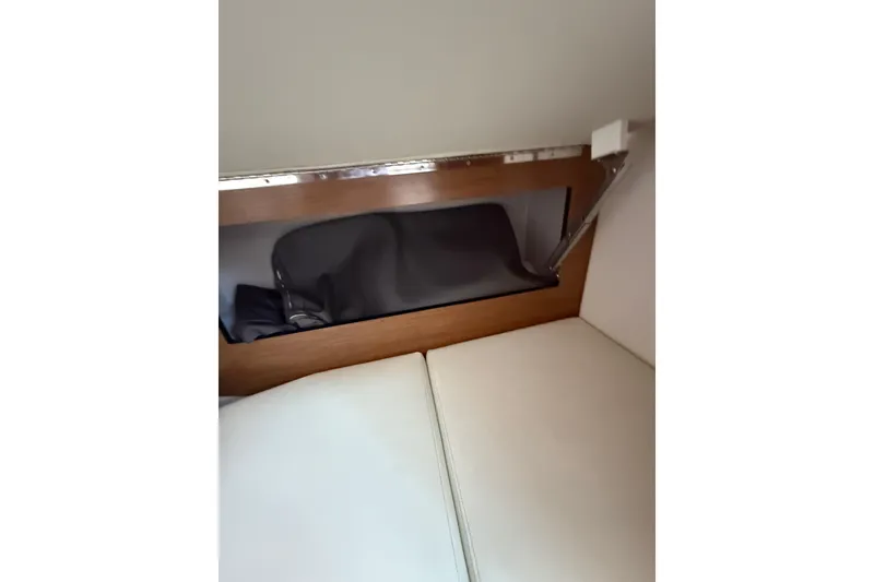 Slide: The Image of 2019 Cruisers Yachts 338 Outboard interior storage compartment with cushion seating. - 40