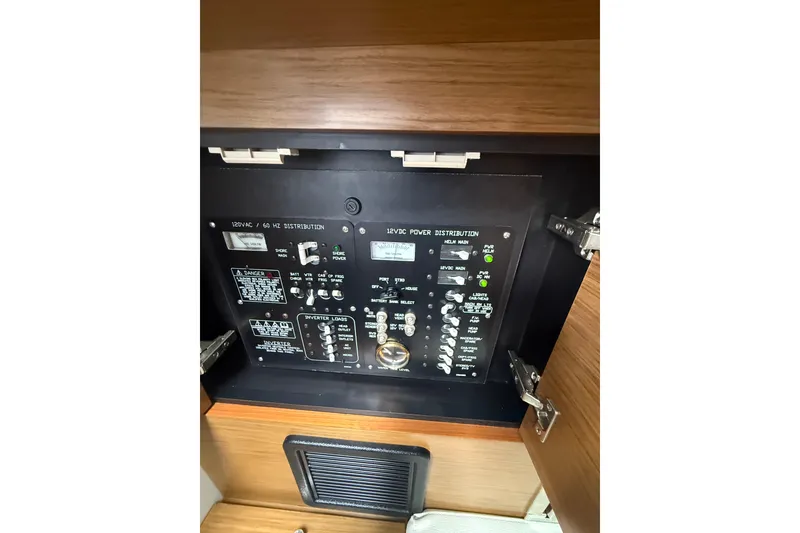 Slide: The Image of Electrical panel inside 2019 Cruisers Yachts 338 Outboard, showcasing power distribution controls. - 43