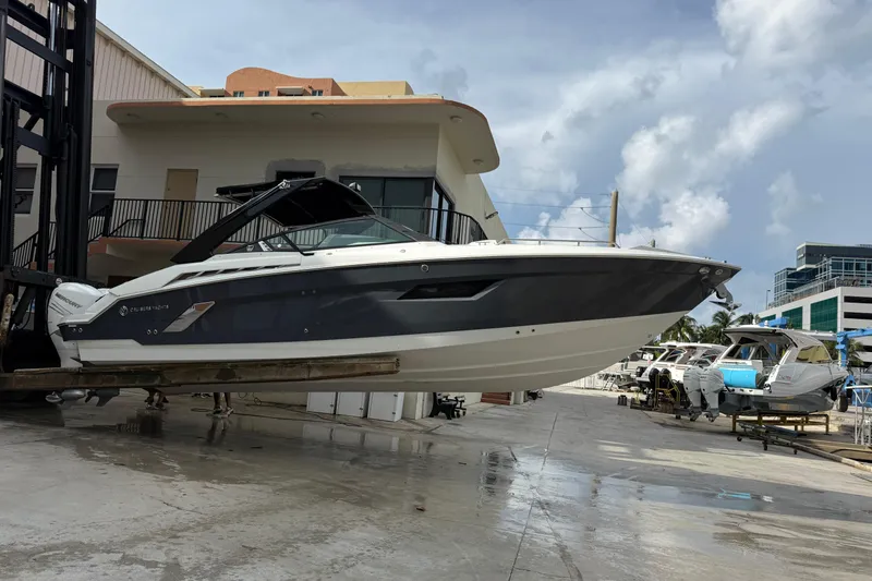 Slide: The Image of 2019 Cruisers Yachts 338 Outboard on lift at marina, ready for launch. - 44