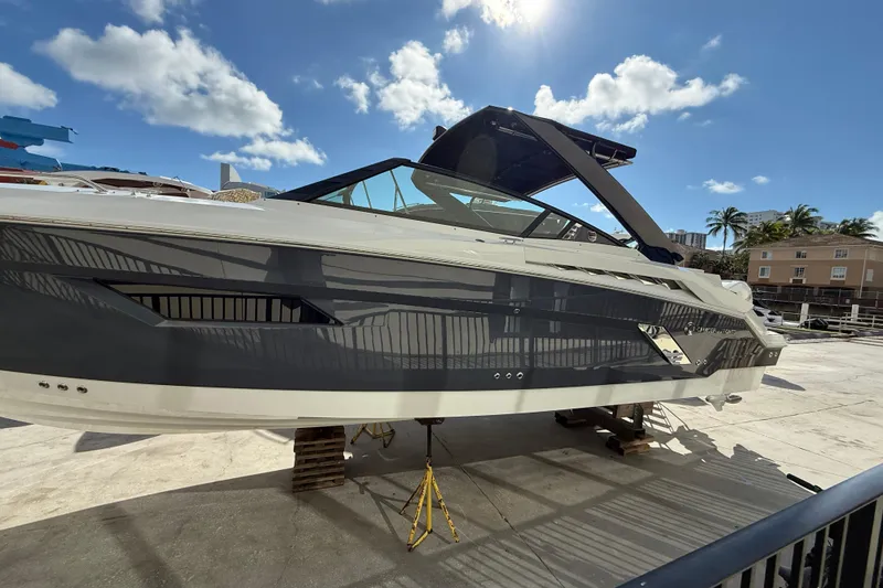 Slide: The Image of 2019 Cruisers Yachts 338 Outboard on dry dock under sunny skies. - 5