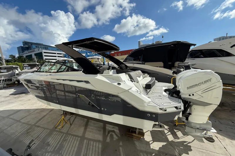 Slide: The Image of 2019 Cruisers Yachts 338 Outboard with Mercury engine, docked under a sunny sky. - 6