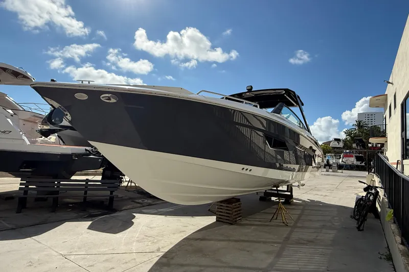Slide: The Image of 2019 Cruisers Yachts 338 Outboard on display under a clear blue sky. - 8