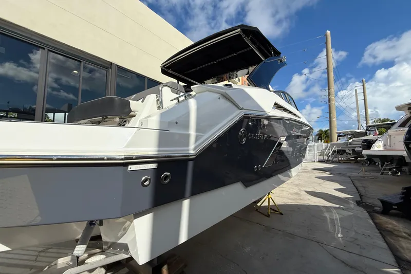 Slide: The Image of 2019 Cruisers Yachts 338 Outboard, docked under a clear blue sky. - 9